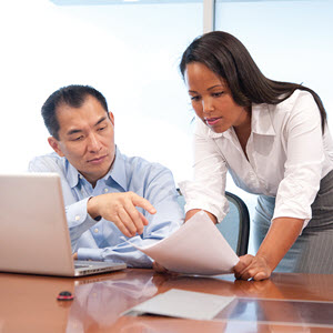 man and woman discussing documents